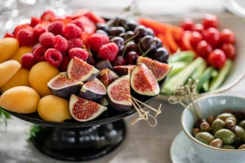 Table with cold snacks and tableware. Fresh Fruit platter on banquet table at Foto stock