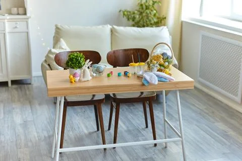 Table with colorful Easter eggs in the interior of the room Foto stock