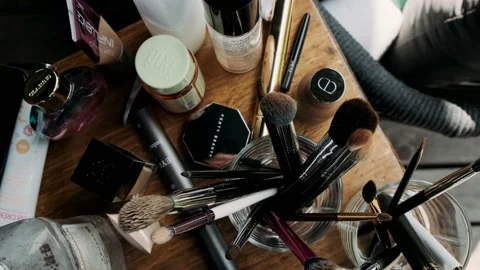 Table with cosmetics and make-up brushes Stock Footage 238373855