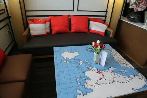 The table is covered with an interactive world map, printed in blue and whi.. Stock Photos