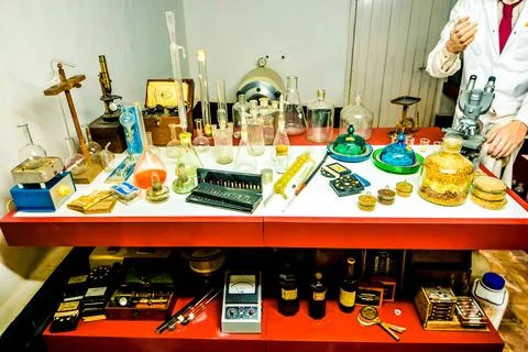 A table is covered with various scientific instruments and chemicals Stock Photos