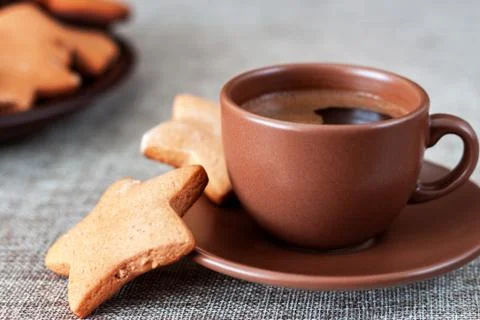On the table is a cup of coffee with gingerbread Stock Photos
