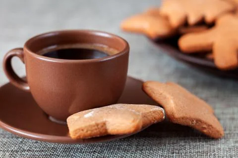On the table is a cup of coffee with gingerbread Stock Photos