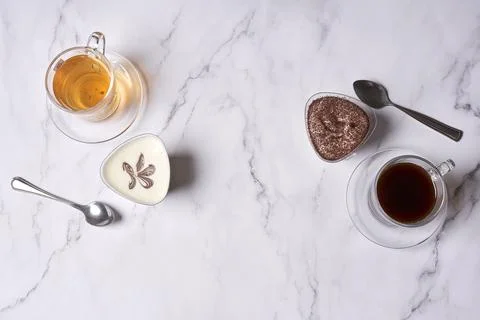 A table with cups of tea and coffee and a Stock Photos