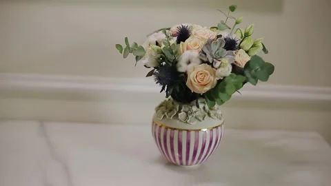 On the table is a decanter with beautiful flowers decorating the room Stock Footage 149429118