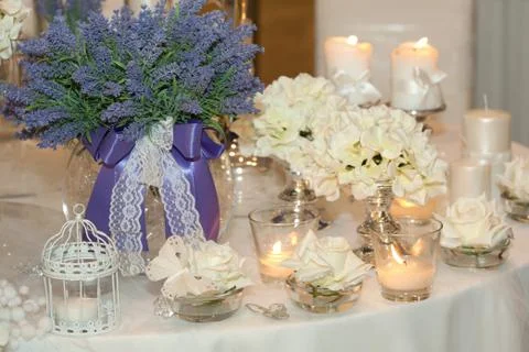 Table decorated with candles, hydrangeas and white roses Stock Photos