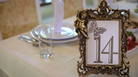 On table is decorated with a festive table number Vídeo Stock 76382596