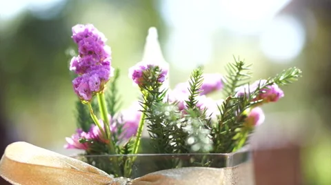 Table decorated with glass vase flowers on ribbon. Beautiful morning sun light Stock Footage 59377899