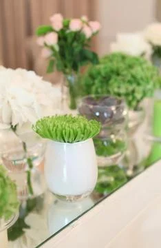 Table decorated in green by using fresh flowers and candles Stock Photos