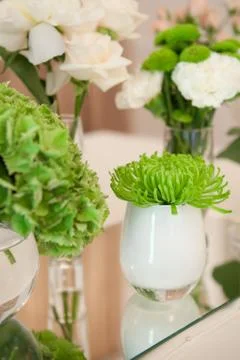 Table decorated in green by using fresh flowers and candles Stock Photos