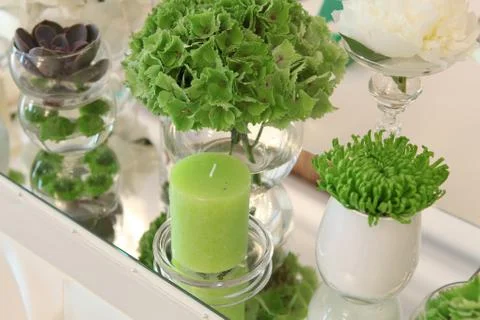 Table decorated in green by using fresh flowers and candles Stock Photos