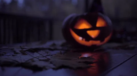 Table decorated with halloween symbol - jack o'lantern, skeleton, witch hat Stock Footage 68986143