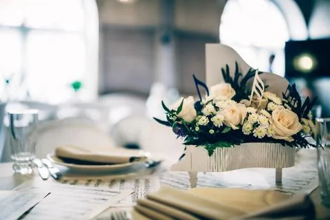 Table decorated with notes and flowers in a small piano Stock Photos