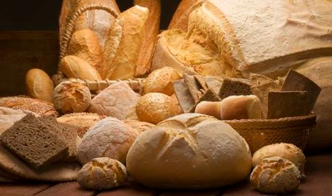 Table decorated with various artisan breads produced with studio light. Stock Photos
