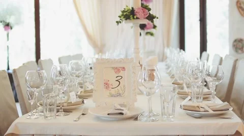 Table Decorated for the Wedding Day. Frame with number and a Flowers Stock Footage 65329864