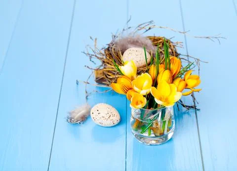 Table decoration with easter eggs, on blue wooden background Stock Photos