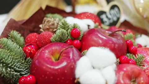 Table decorations are red apples and spruce branches. Media. Close-up of food Stock Footage 253714635