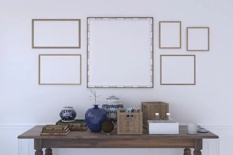 Table with decorative items under a wall with multiple frames Stock Photos