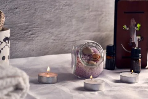 A table with different spa elements including candles, set of towels, diffuse Stock Photos