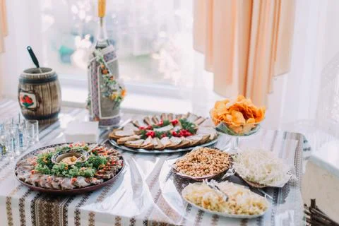 Table of different tasty snacks, served in traditional east slavic rurral sty Stock Photos