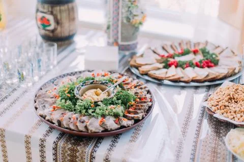 Table of different tasty snacks, served in traditional east slavic rurral sty Stock Photos
