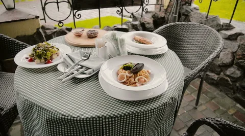 Table with dishes in a cafe on the street Stock Footage 63231798