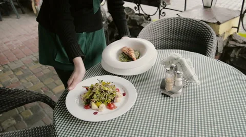 Table with dishes in a cafe on the street Stock Footage 63232164