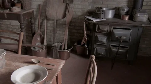 Table, dishware, crockery, cutlery in a poor kitchen of an old house. Video stock 73940405