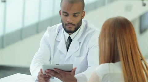 On the table, the doctor is a tablet and an x-ray of the patient Stock Footage 43505266