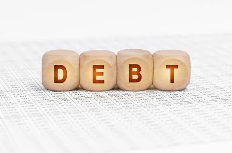On the table with documents are wooden cubes with the inscription - DEBT Stock Photos