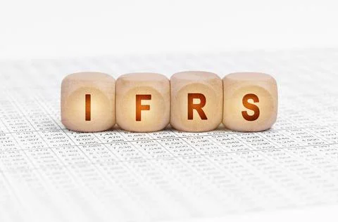 On the table with documents are wooden cubes with the inscription - IFRS Stock Photos