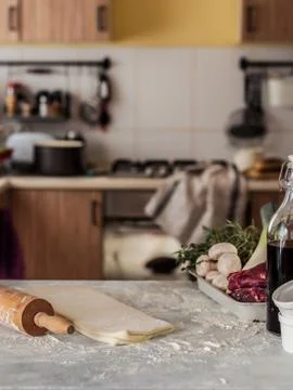 Table with Dough and Blurred Kitchen Stock-Fotos