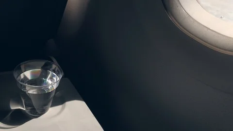 Table with drink on a plane Stock Footage 110894985