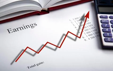 Table with earnings with digits, calculator and diagram Stock Photos