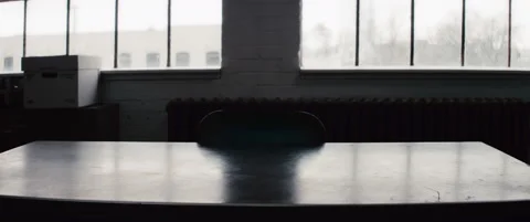 Table with an empty chair in a room with big windows - reenactment Stock Footage 202905699