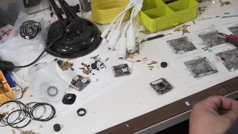 Table in the Engineer's Workshop with microcircuits, bolts, wires. The man's Stock Footage 142725859