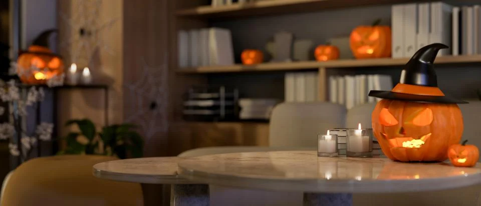 A table features candle lights and Halloween pumpkin lights in a room on Ha.. イラスト素材