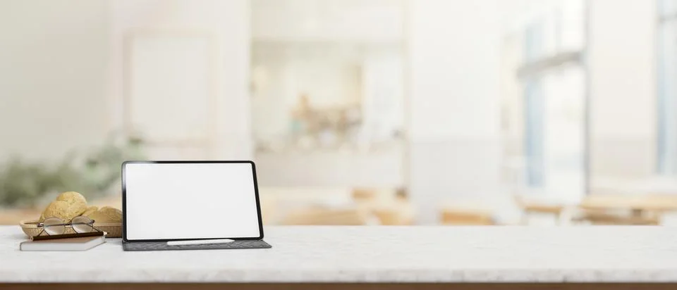 A table features a digital tablet mockup with a blurred background of a mod.. Stock Illustration