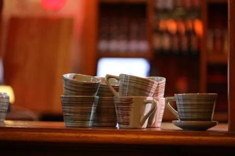 A table filled with cups, suitable for still life photography or as a prop in Stock Photos