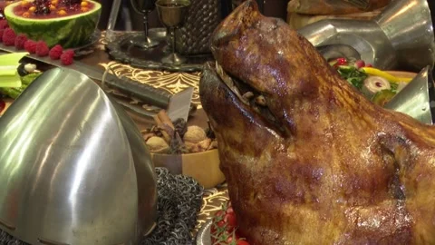 On the table is the finished dish, a fried pig's head, various snacks. Video stock 123923238