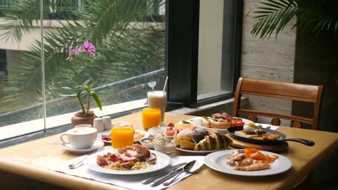 Table with food and drinks for dinner, lunch or brunch in restaurant or cafe 動画素材 165488920