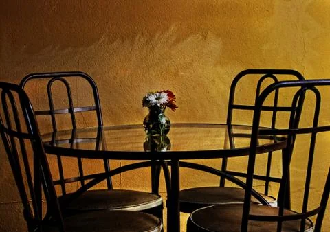 Table with four chairs in rustic place Stock Photos