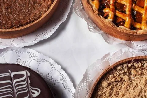 A table with four different types of pies and cakes Stock Photos