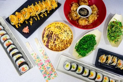 A table full of different types of sushi and other Asian food Stock Photos