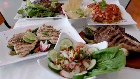 Table full of difficult choices of Mexican grilled meals to choose from Stock Footage 169262618