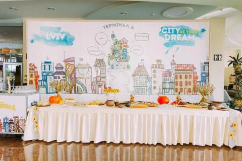 The table full of food is placed at the background of the big poster Foto stock