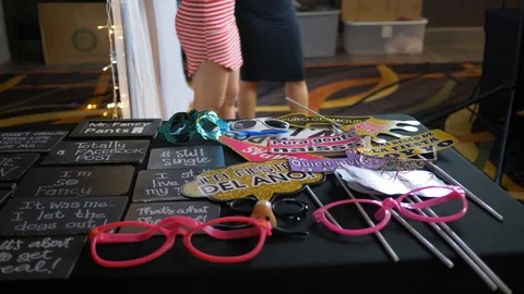 Table full of photo booth props and signs. Stock Footage 100528548