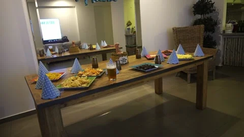 A table full of snacks and a penis cake for a surprise birthday party Vidéo 194502384