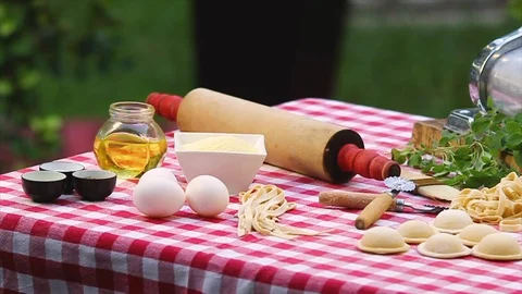Table in a garden with different kind of ingredients and utensils to prepare Ita Stock Footage 91046561