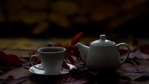 On the table is hot tea and teapot steam comes from a cup. Stock Footage 120427296